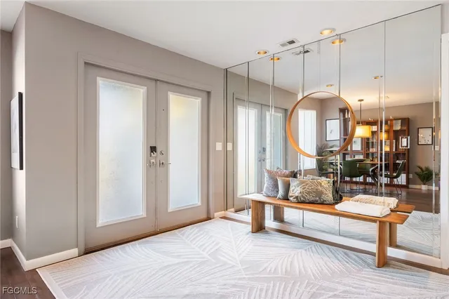 a bedroom with furniture and a large window