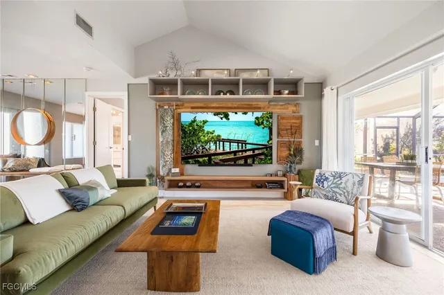 a spacious bedroom with a bed couch and a large window