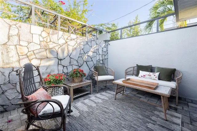 a living room with furniture and flowers