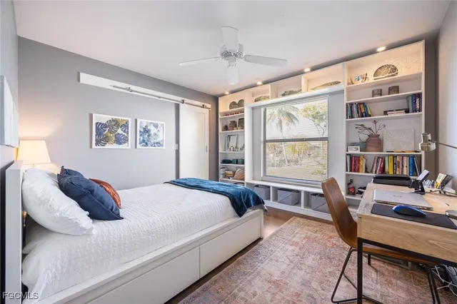 a spacious bedroom with a bed and a large window