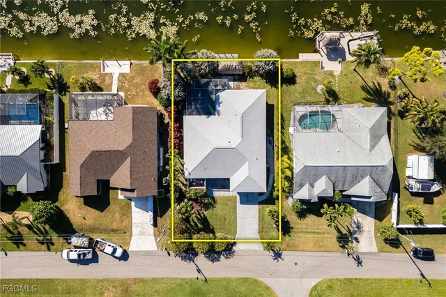 a view of a house with a yard and sitting area
