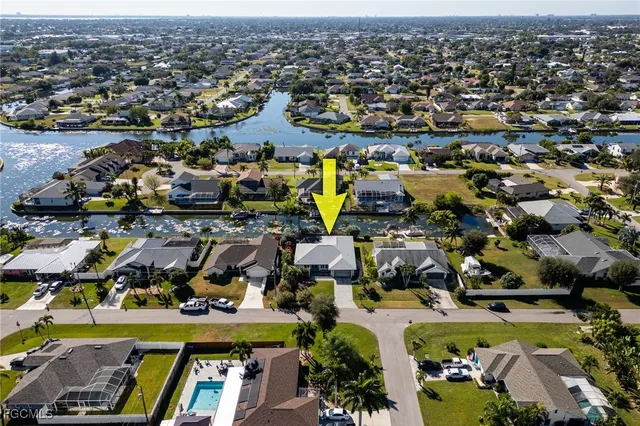 an aerial view of a houses with a lake view