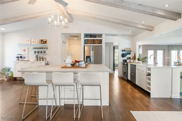 a kitchen with a table chairs stove and cabinets