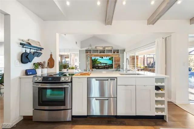 a kitchen with stainless steel appliances granite countertop a stove and a refrigerator