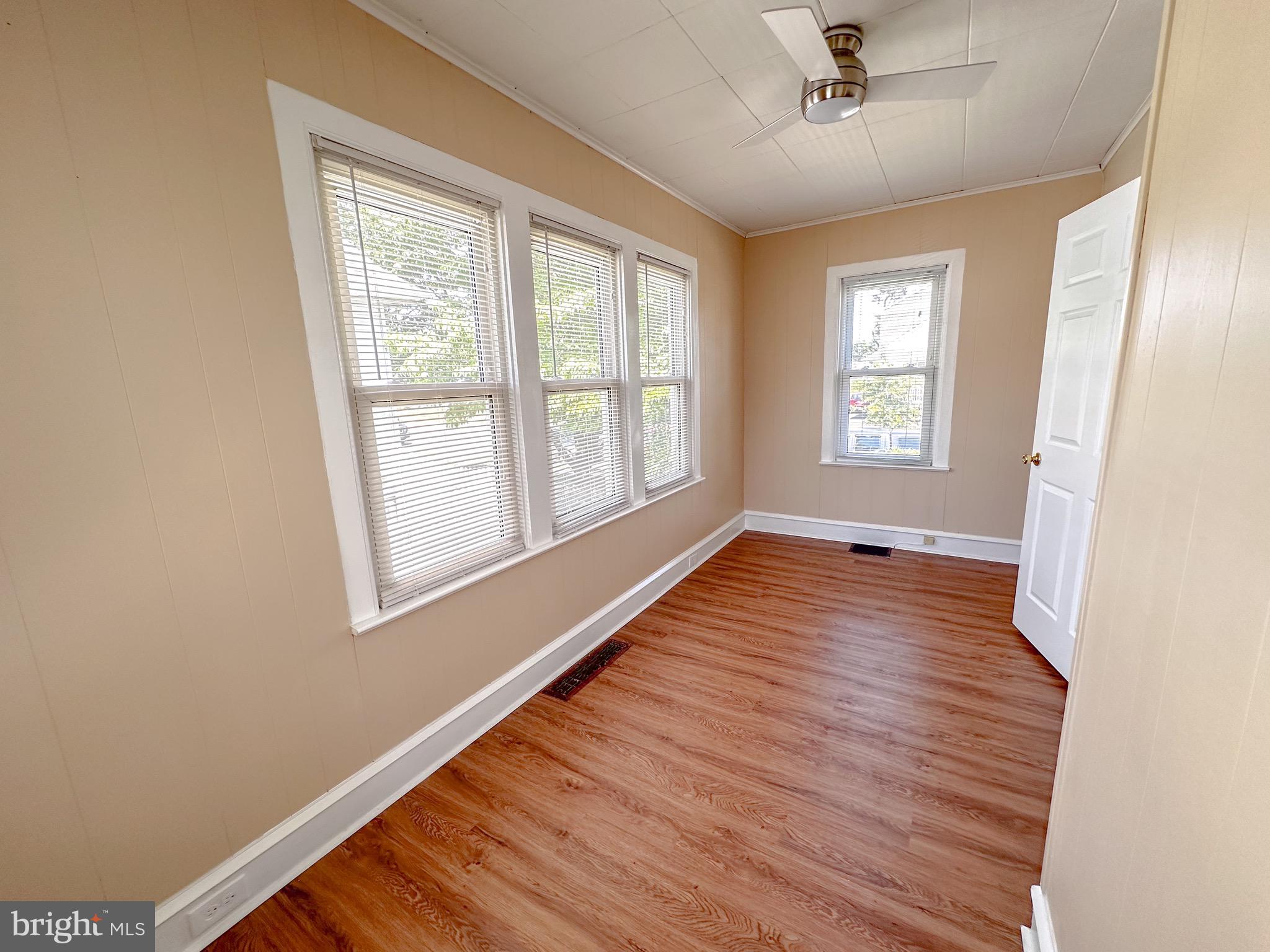 116 East Clinton Avenue Haddon Township, NJ 08107 - Photo 12 of 44 a view of an empty room with wooden floor and a window