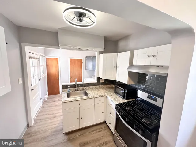 a kitchen with a stove a sink and a refrigerator