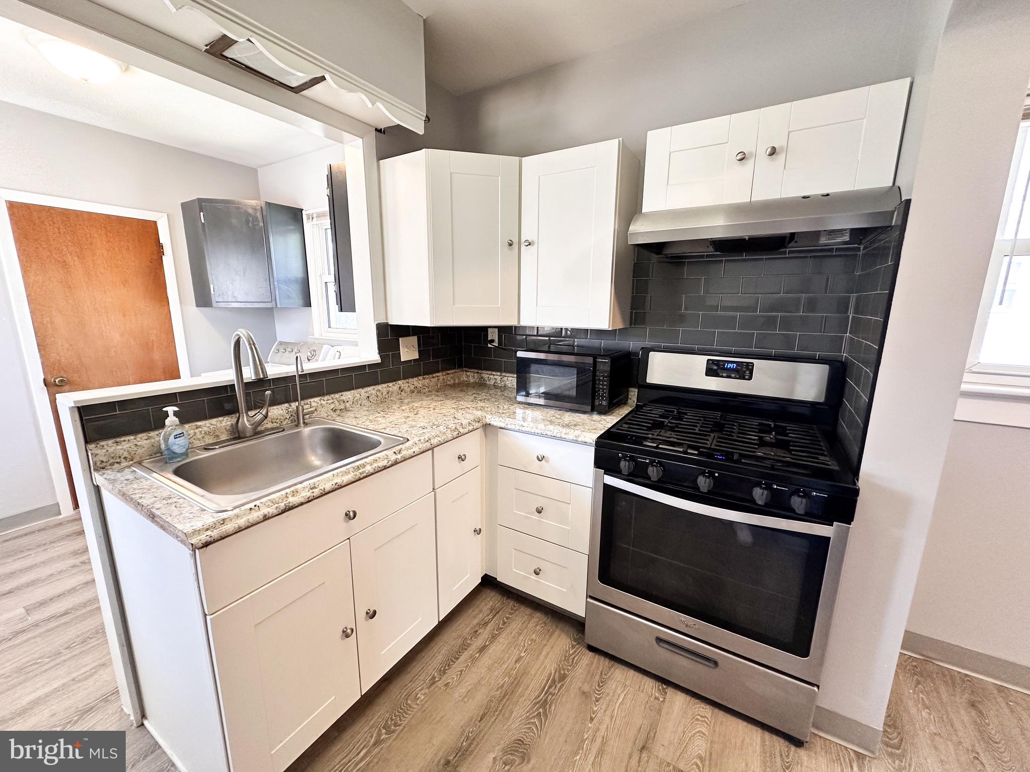 116 East Clinton Avenue Haddon Township, NJ 08107 - Photo 16 of 44 a kitchen with a sink stove and cabinets
