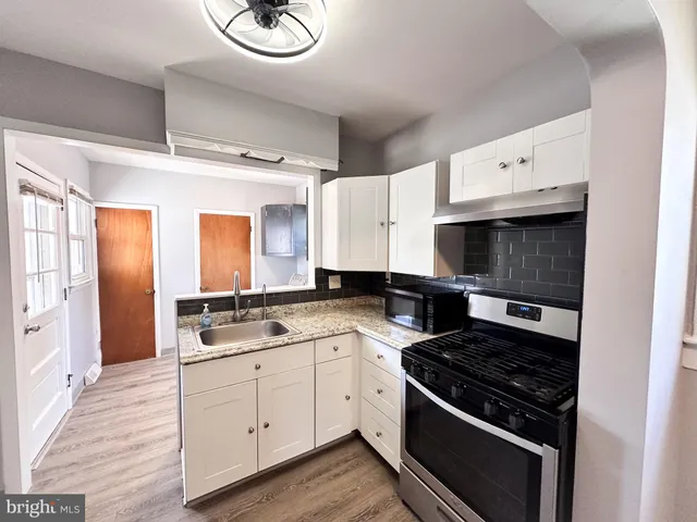 a kitchen with a stove and a sink