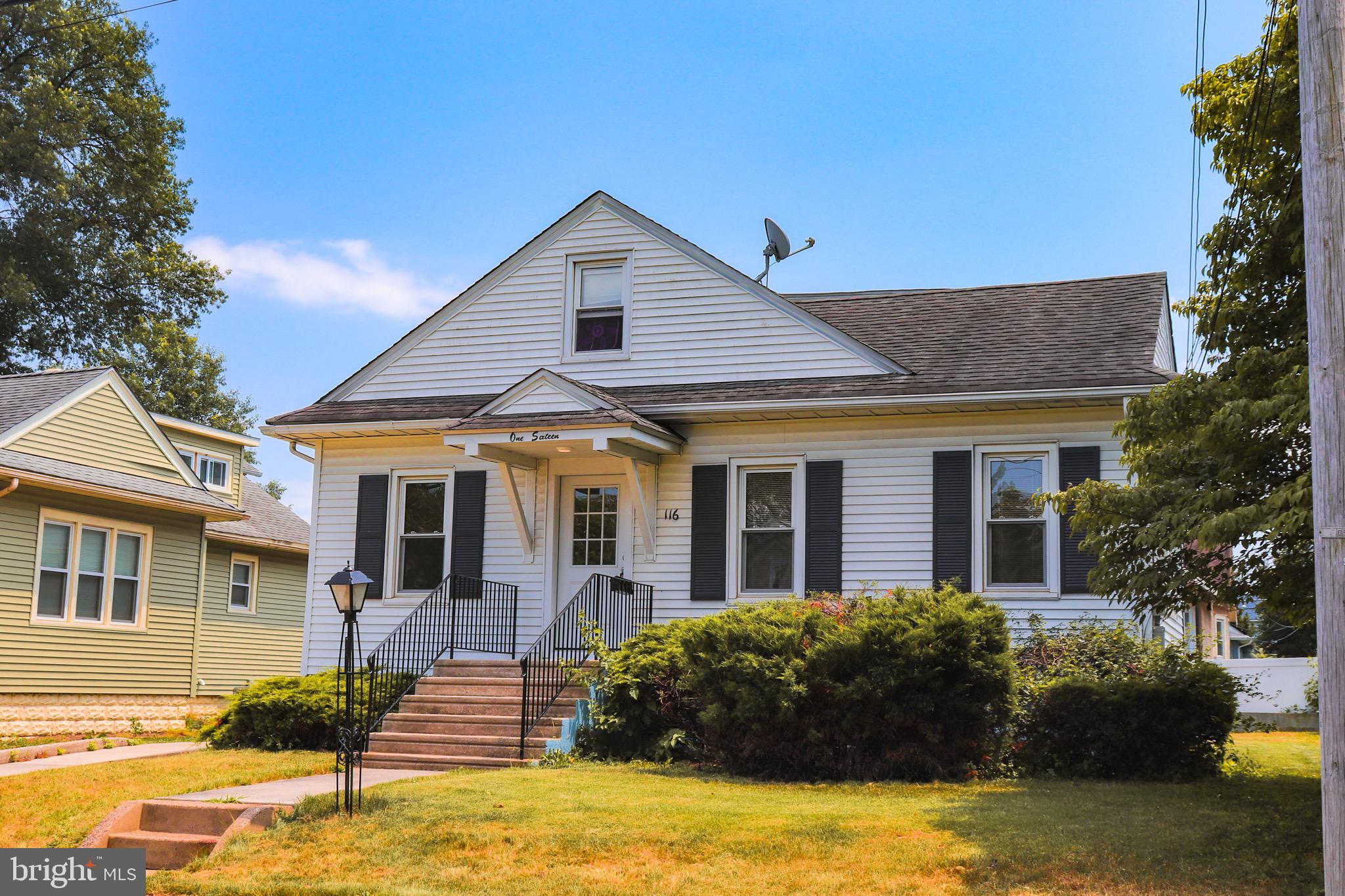 116 East Clinton Avenue Haddon Township, NJ 08107 - Photo 2 of 44 a view of a white house with a large windows and a yard with plants and trees