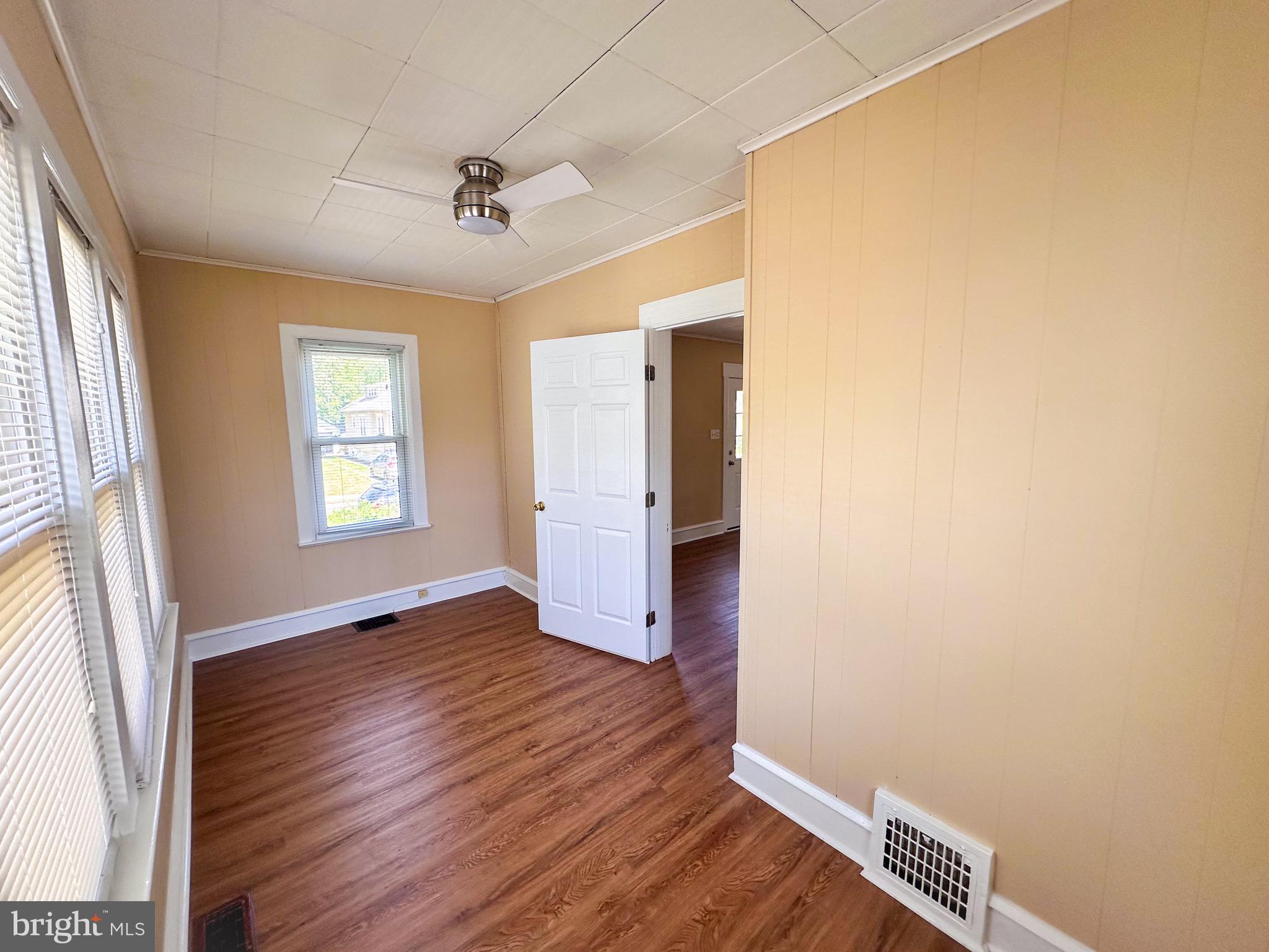 116 East Clinton Avenue Haddon Township, NJ 08107 - Photo 3 of 44 an empty room with wooden floor and windows