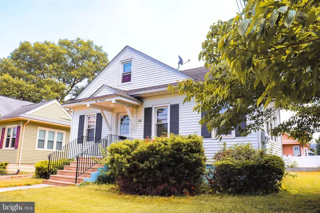 a view of a house with pool and wooden fence