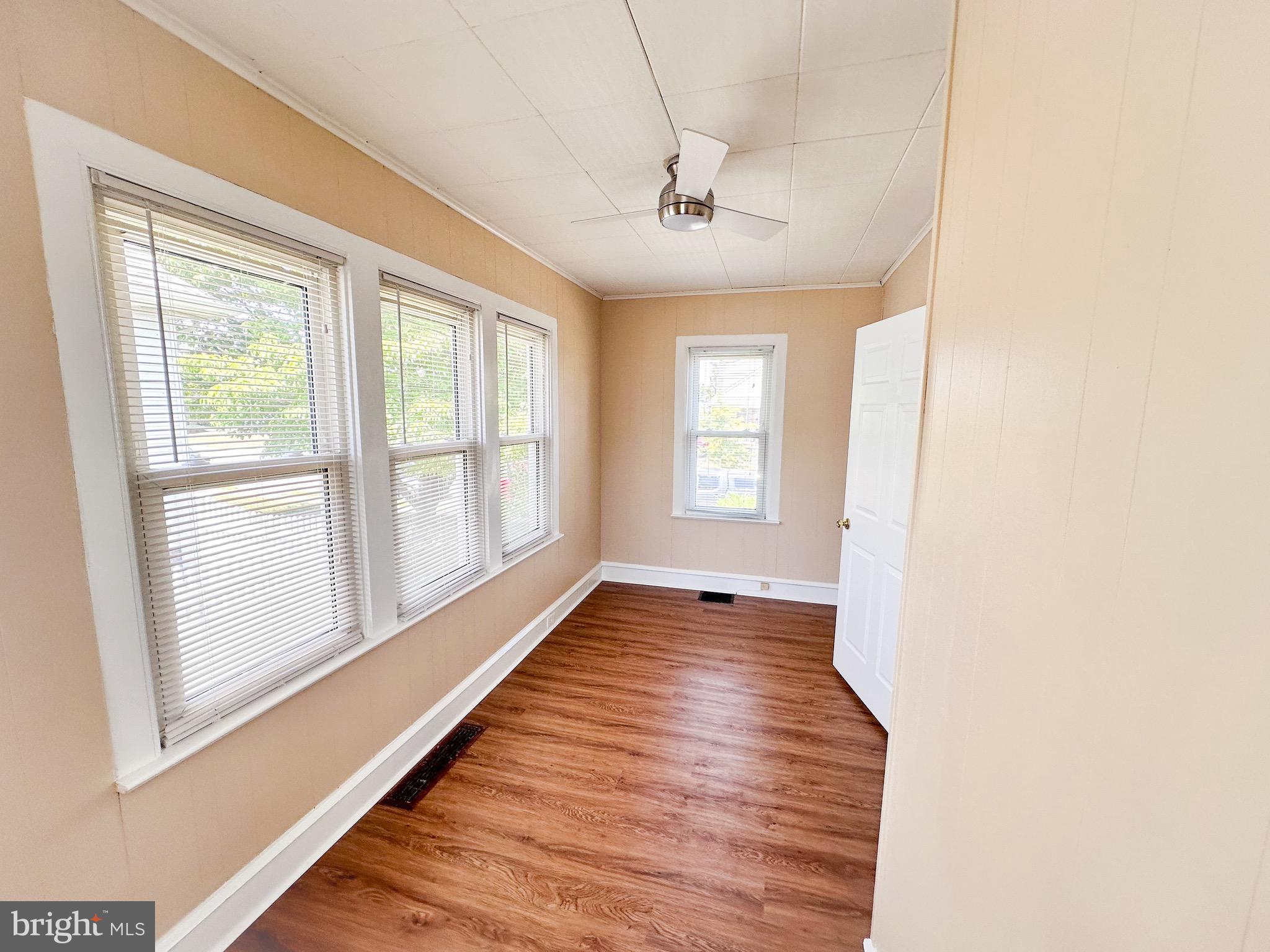 116 East Clinton Avenue Haddon Township, NJ 08107 - Photo 4 of 44 a view of an empty room with wooden floor and a window