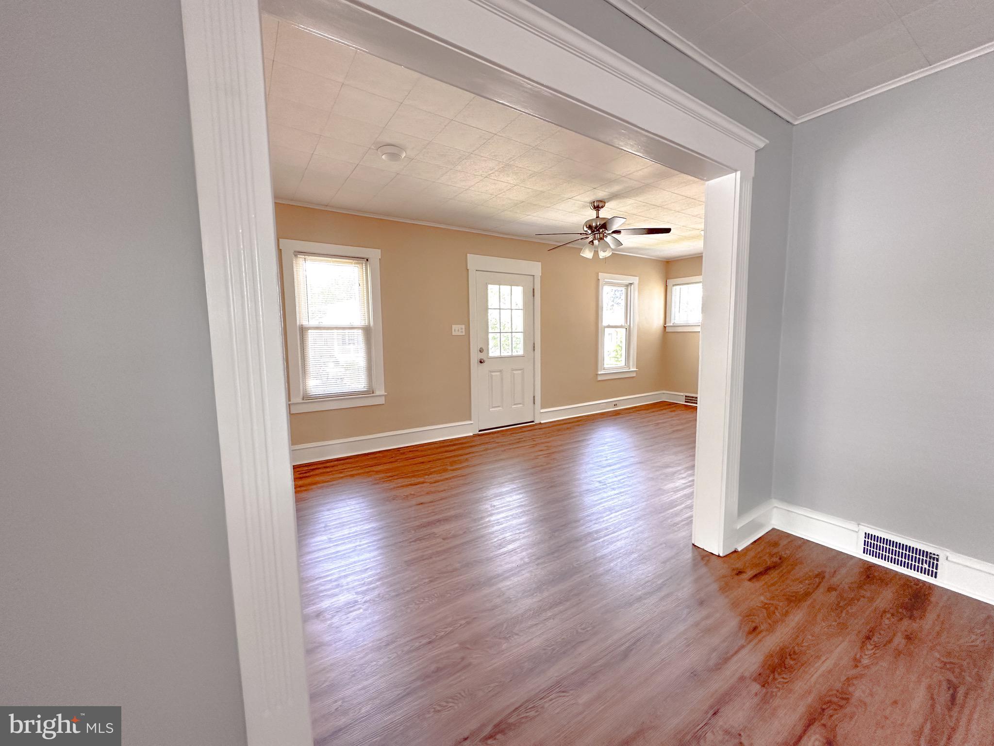 116 East Clinton Avenue Haddon Township, NJ 08107 - Photo 9 of 44 an empty room with wooden floor and windows