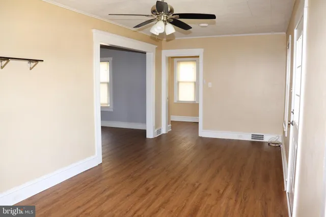 wooden floor in an empty room with a window