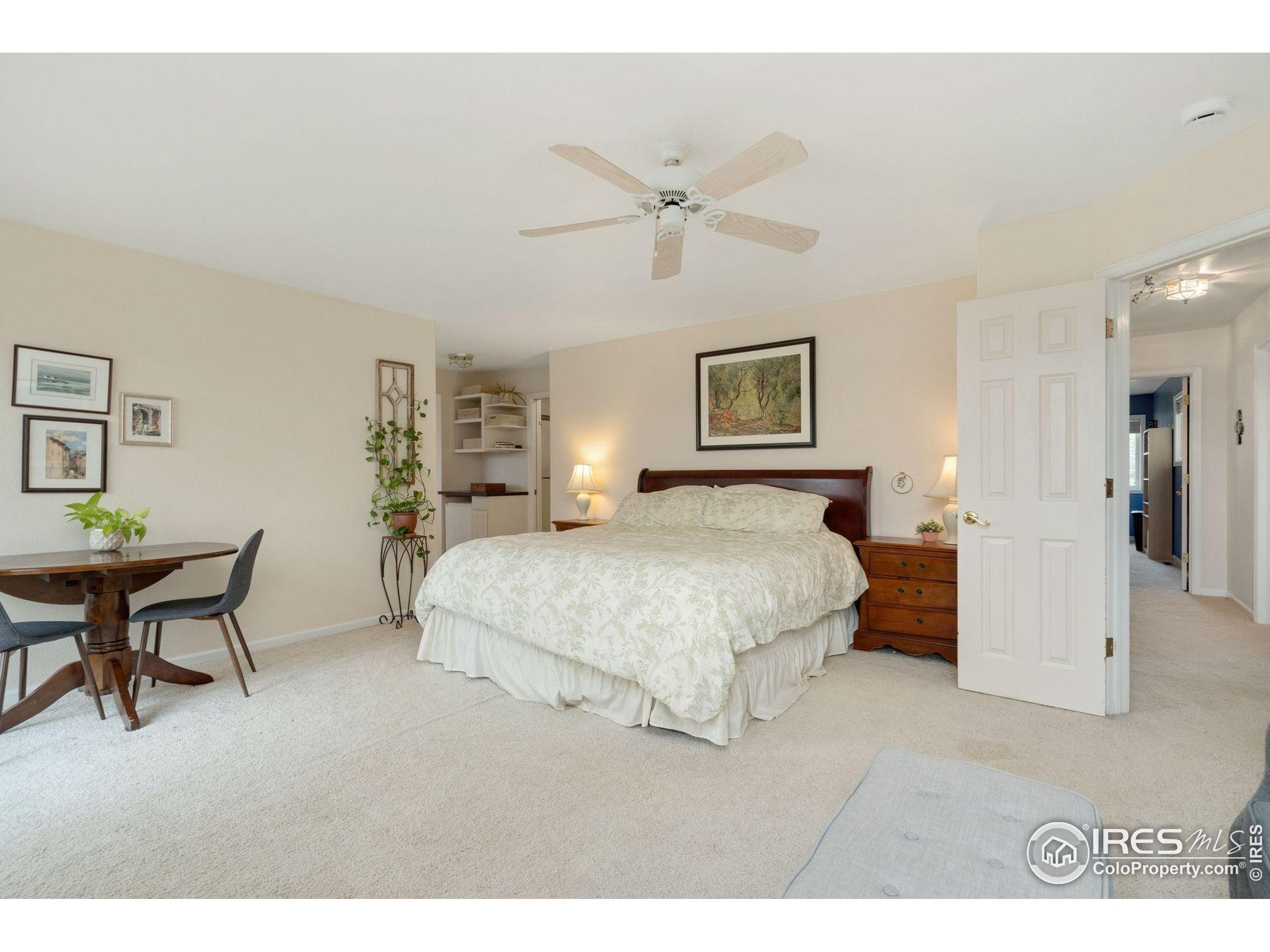 1055 Coho Run Fort Collins, CO 80524 - Photo 15 of 50 a spacious bedroom with a bed a table and chair