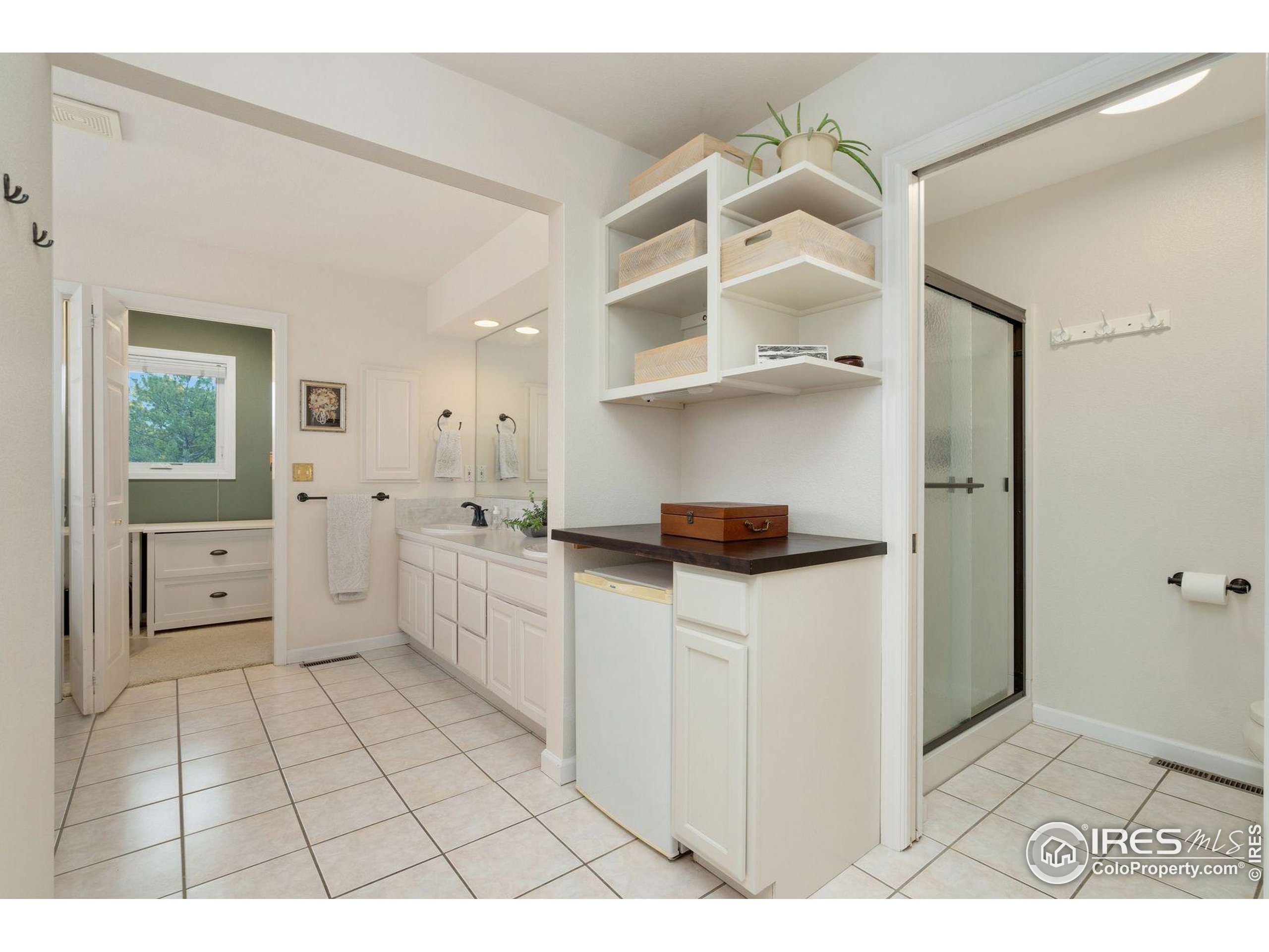 1055 Coho Run Fort Collins, CO 80524 - Photo 16 of 50 a kitchen with white cabinets and window