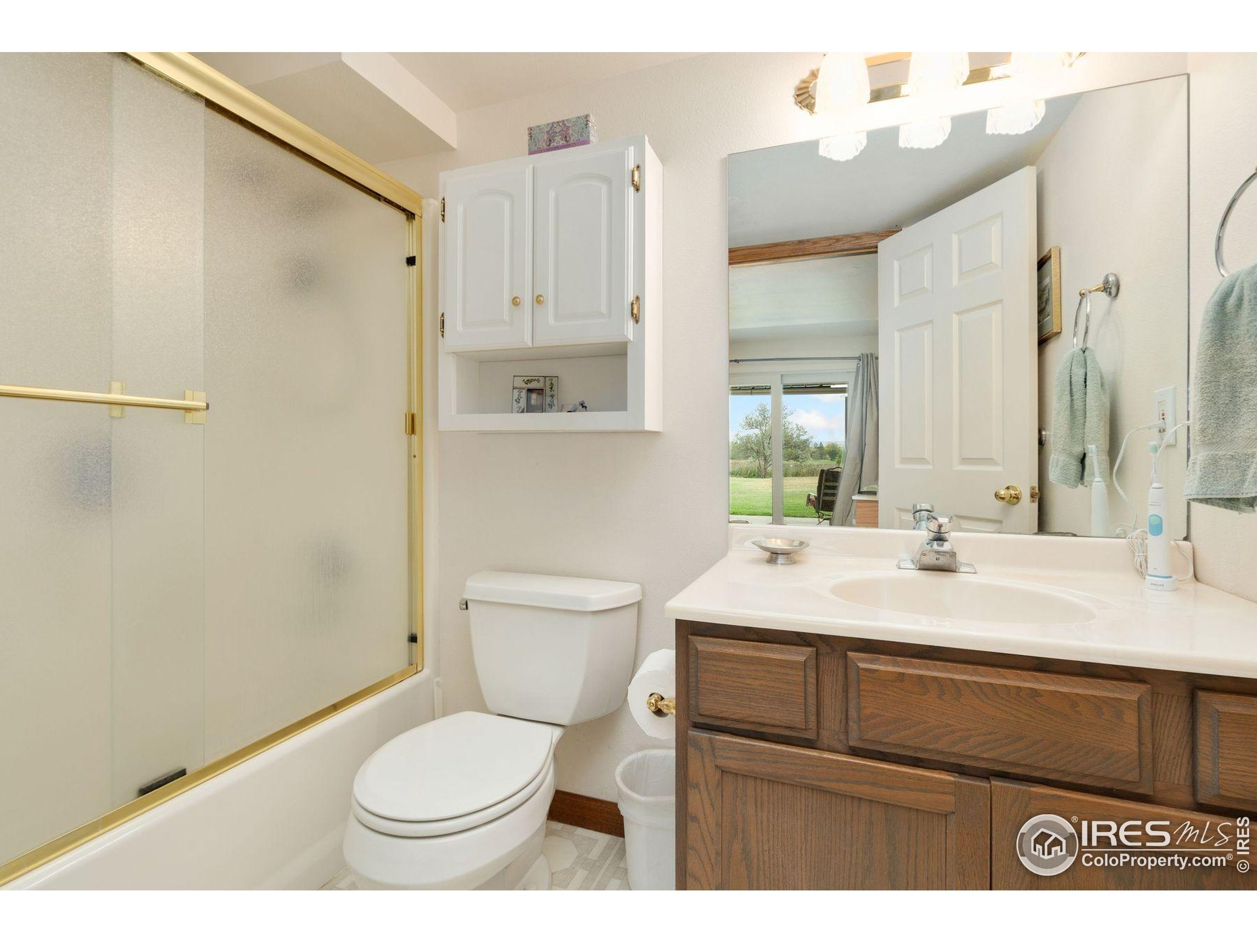1055 Coho Run Fort Collins, CO 80524 - Photo 26 of 50 a bathroom with a sink toilet vanity and shower