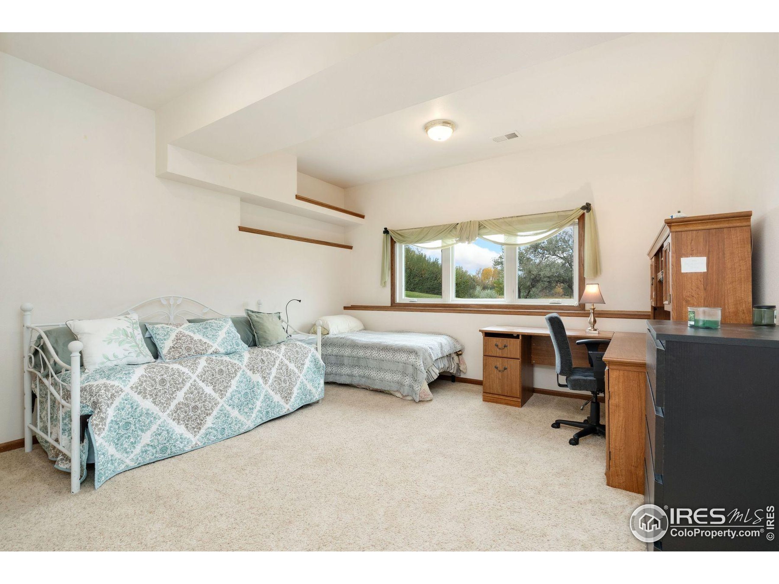 1055 Coho Run Fort Collins, CO 80524 - Photo 27 of 50 a bedroom with furniture and a large window
