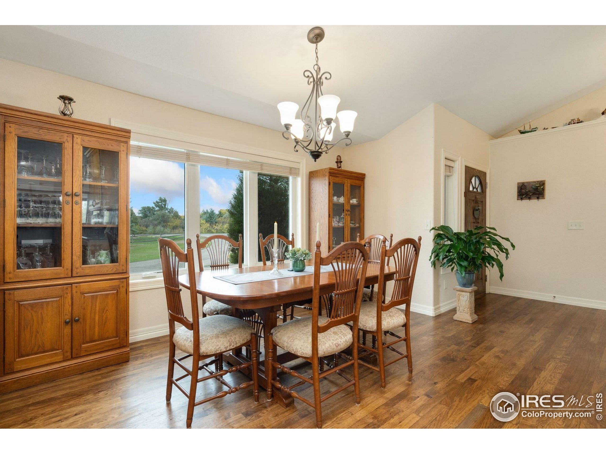 1055 Coho Run Fort Collins, CO 80524 - Photo 32 of 50 a view of a dining room with furniture window and wooden floor