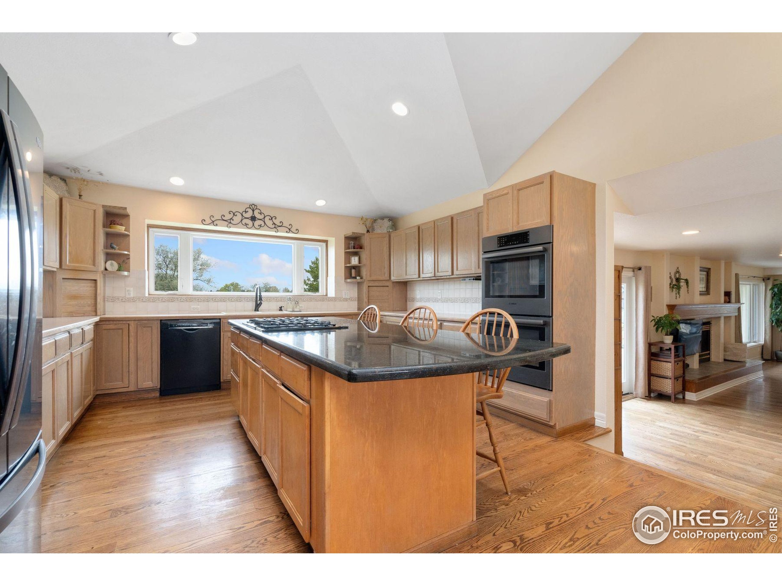 1055 Coho Run Fort Collins, CO 80524 - Photo 4 of 50 a kitchen with stainless steel appliances granite countertop a sink and a refrigerator
