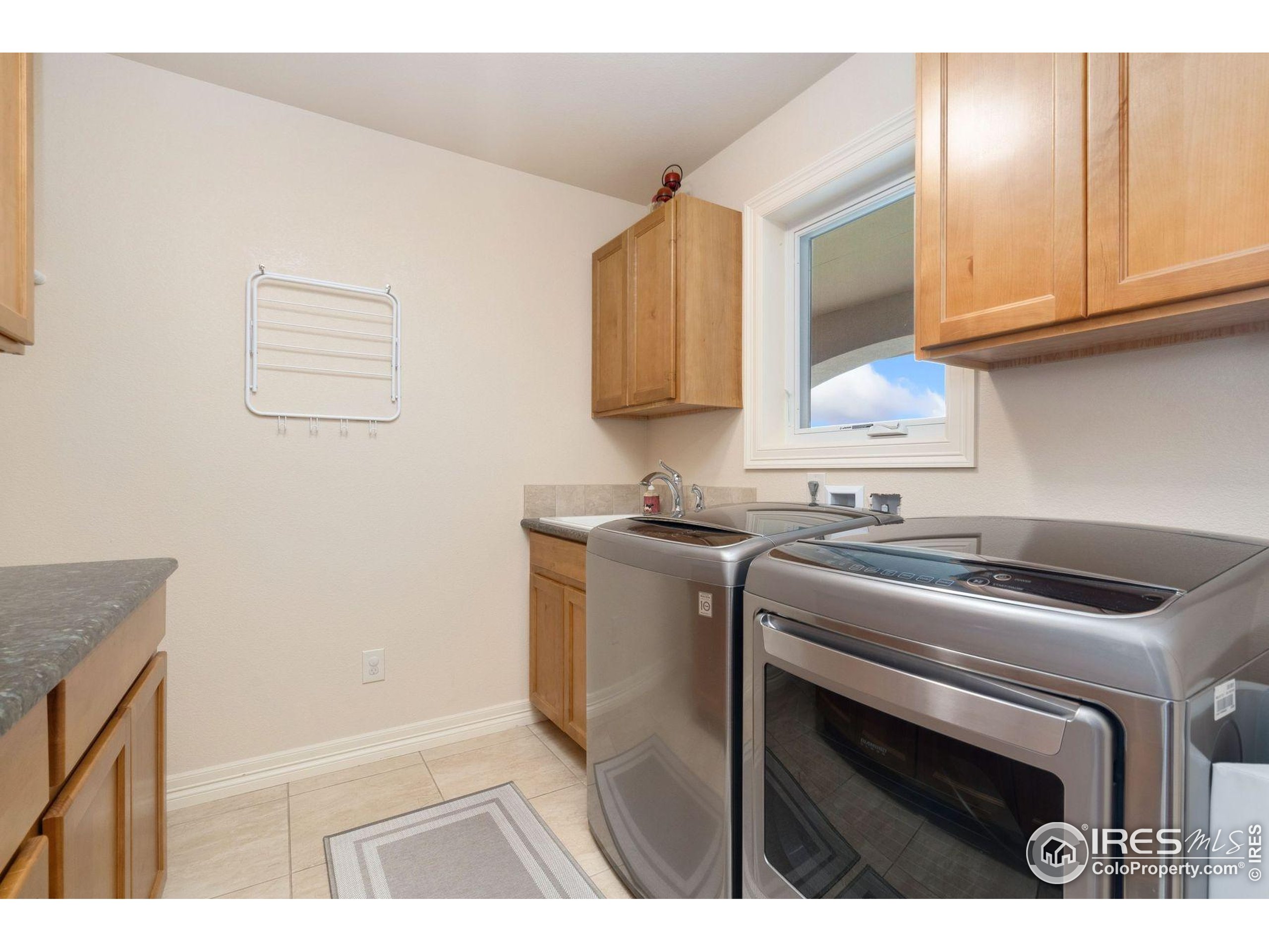 1055 Coho Run Fort Collins, CO 80524 - Photo 41 of 50 a utility room with sink dryer and washer
