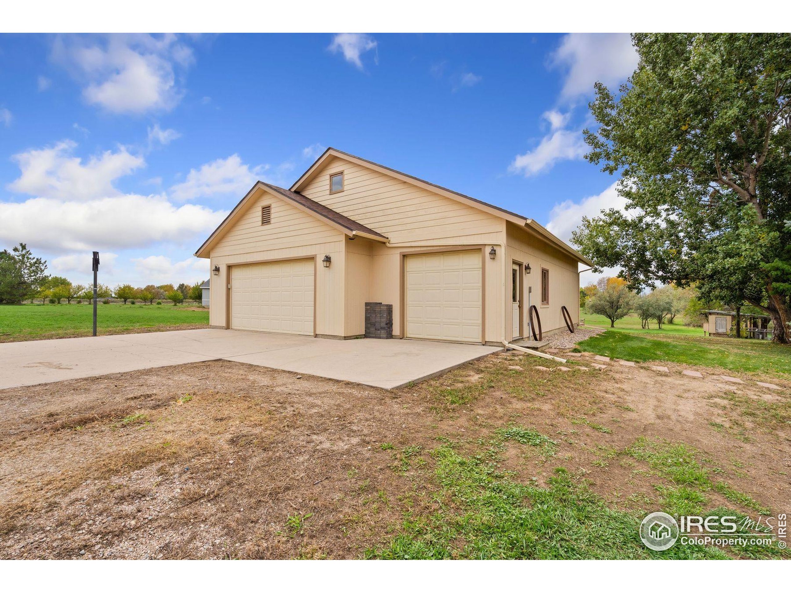 1055 Coho Run Fort Collins, CO 80524 - Photo 44 of 50 a view of a house with a yard and garage
