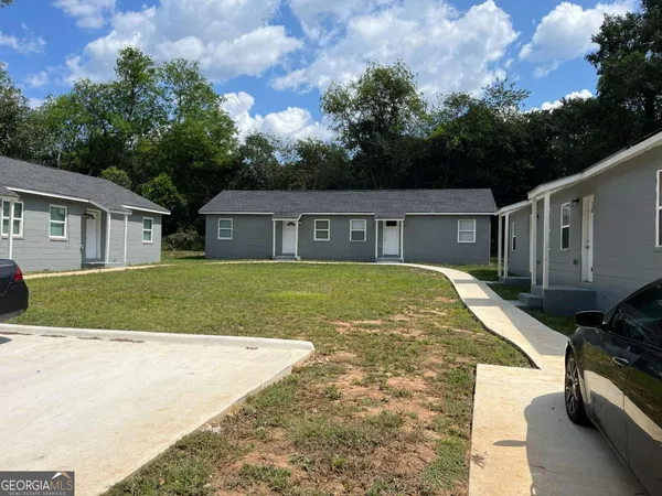 a view of house that has a yard