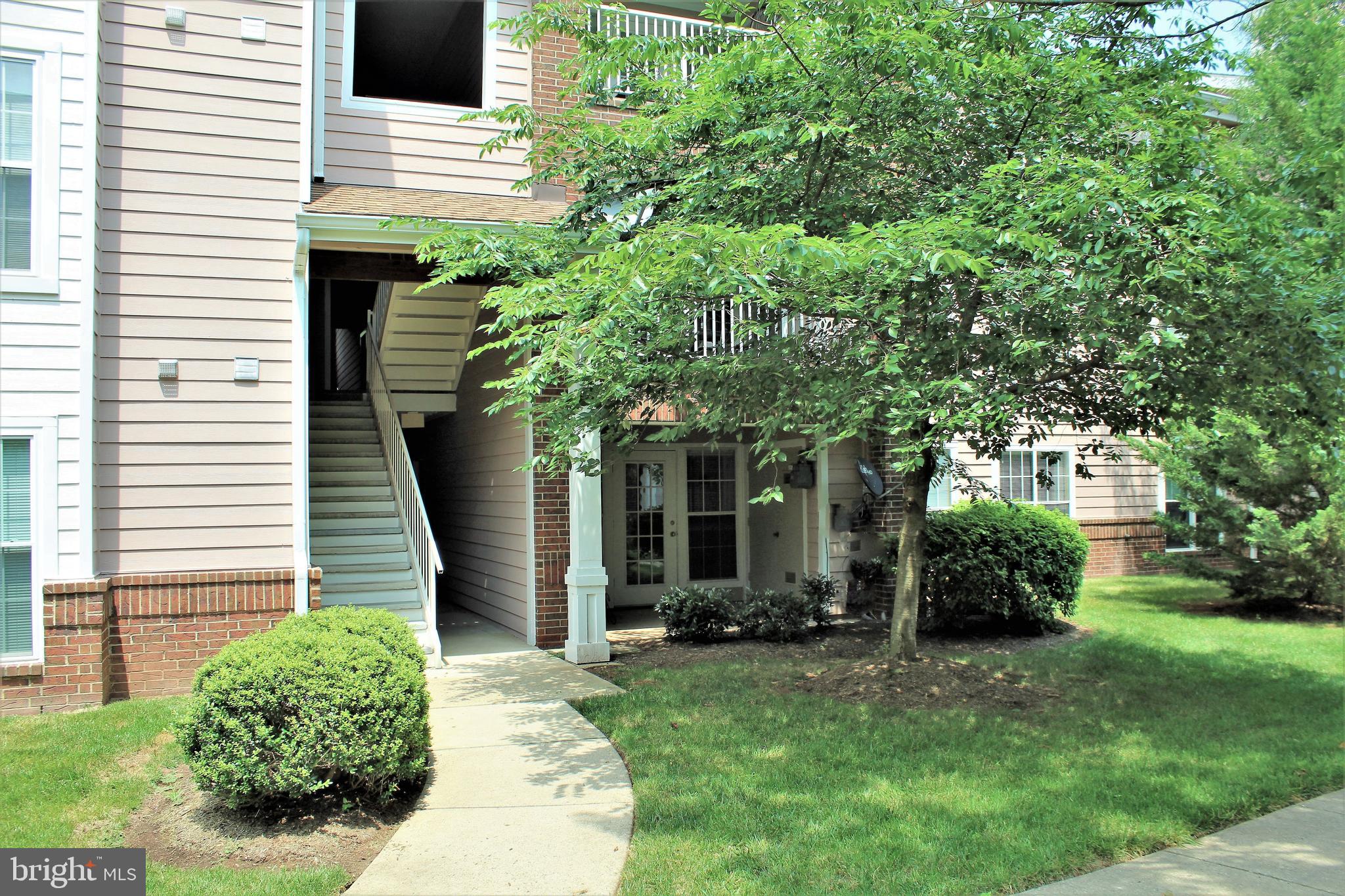 21023 Timber Ridge Terrace, Unit 103 Ashburn, VA 20147 - Photo 2 of 8 Walkway Leading to Unit 103 w/Patio
