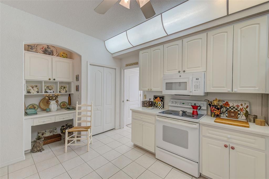 4 Poppy Court Homosassa, FL 34446 - Photo 17 of 55 a kitchen with white cabinets and white appliances