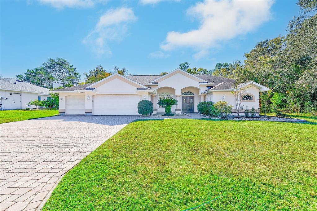 4 Poppy Court Homosassa, FL 34446 - Photo 2 of 55 a front view of a house with garden