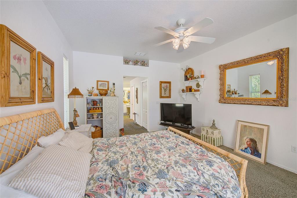 4 Poppy Court Homosassa, FL 34446 - Photo 25 of 55 a bed room with a bed and a chandelier