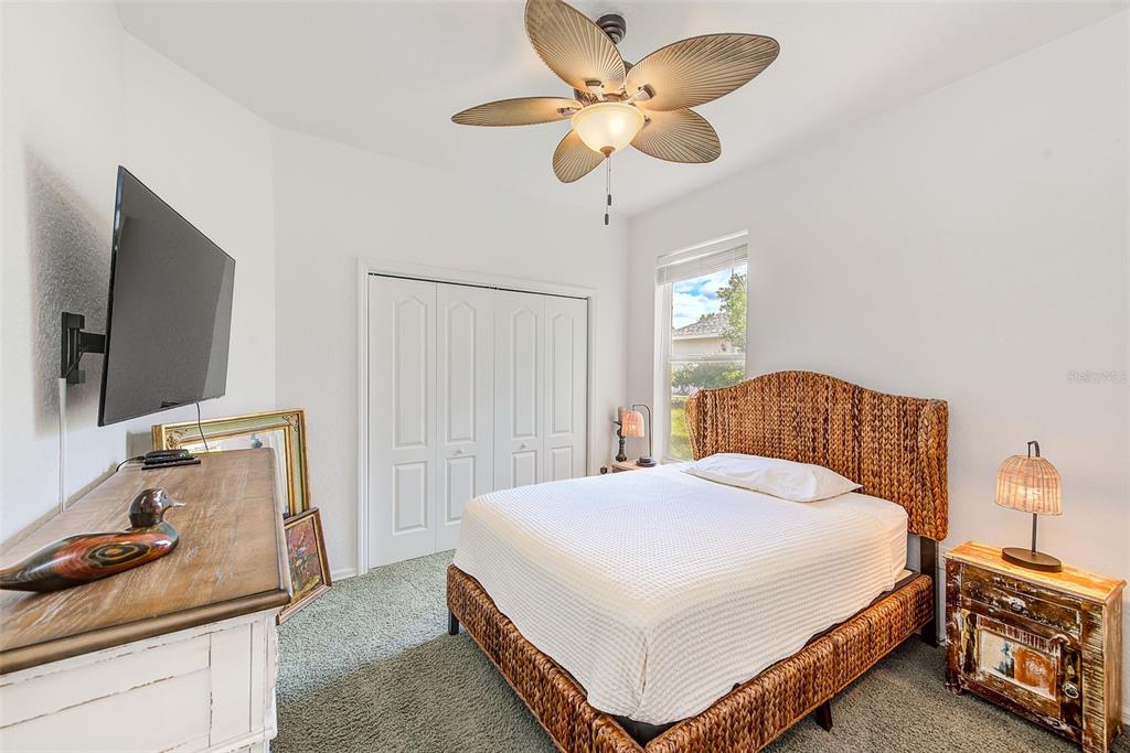 4 Poppy Court Homosassa, FL 34446 - Photo 30 of 55 a bedroom with a bed and a flat tv screen on dresser