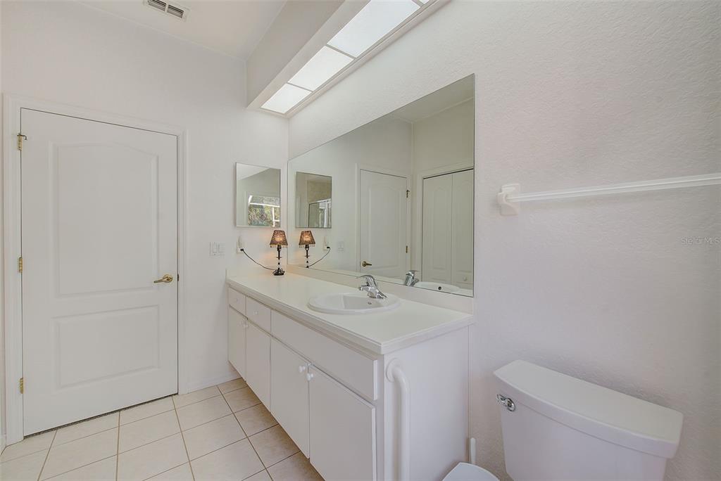 4 Poppy Court Homosassa, FL 34446 - Photo 36 of 55 a spacious bathroom with a toilet sink and mirror