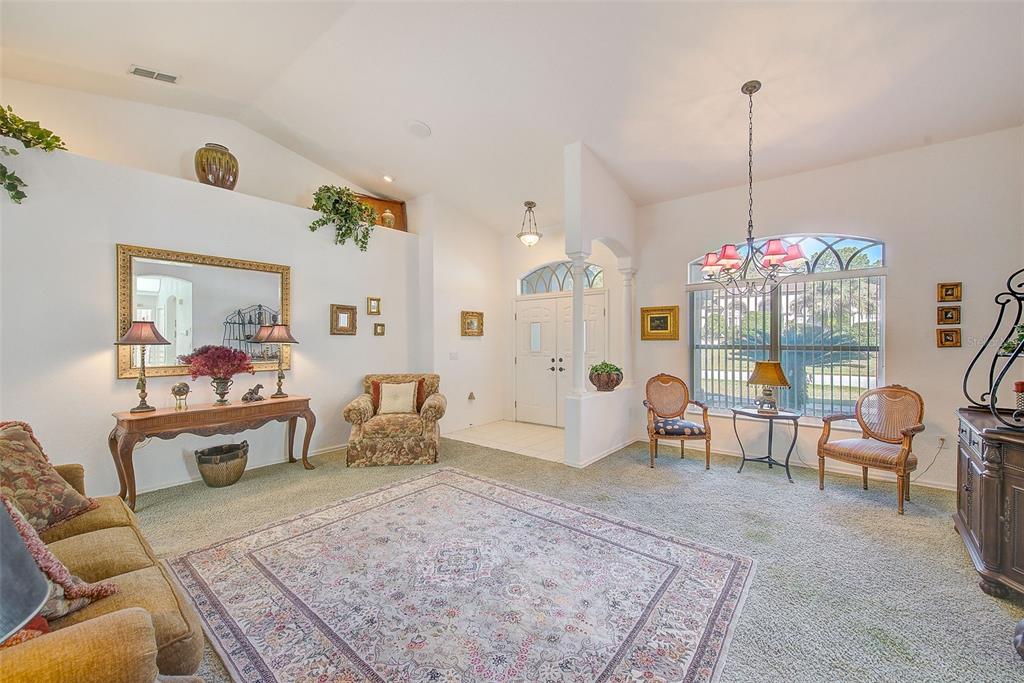 4 Poppy Court Homosassa, FL 34446 - Photo 8 of 55 a living room with furniture and a chandelier