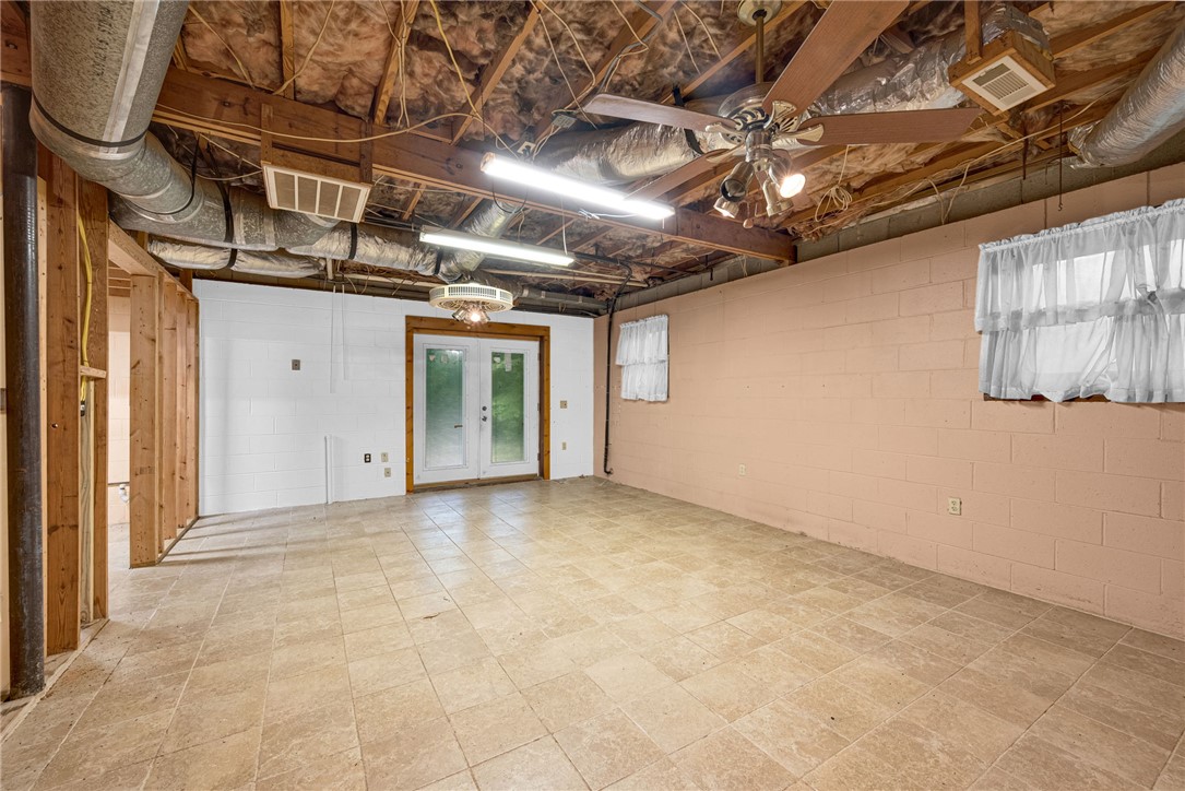 237 Spring Valley Road Liberty, SC 29657 - Photo 20 of 50 A partially finished basement with tiled flooring and convenient outdoor access.