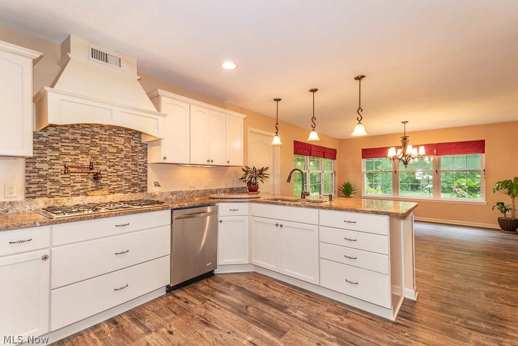 1074 Dock Road Madison, OH 44057 - Photo 6 of 35 Gourmet kitchen with stainless steel appliances. Custom ceramic backsplash above built in stovetop with "pot filler."
