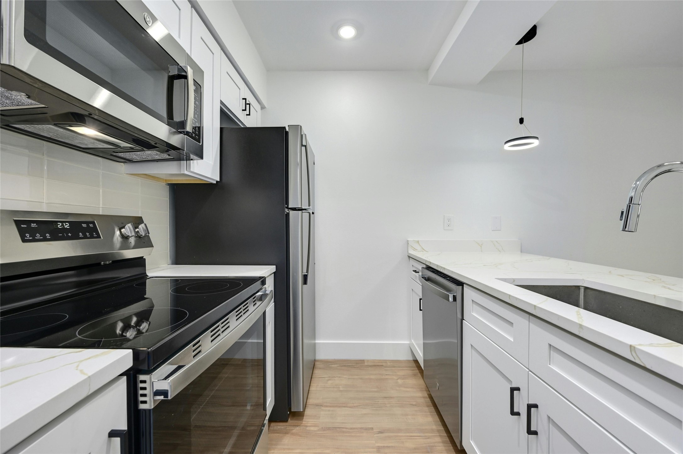 202 East 45th Street, Unit 103 Austin, TX 78751 - Photo 12 of 27 a kitchen with stainless steel appliances granite countertop a refrigerator and a stove