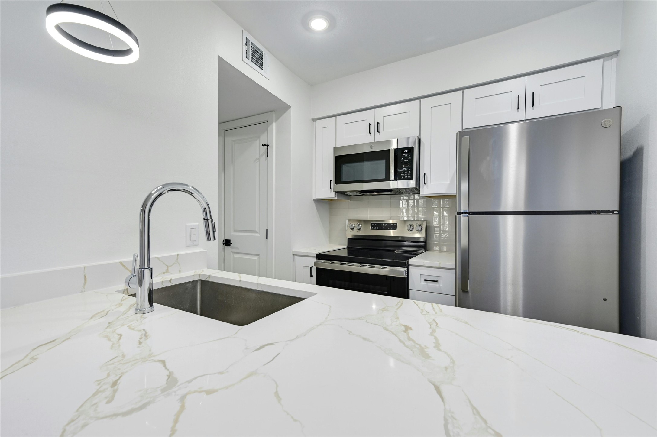 202 East 45th Street, Unit 103 Austin, TX 78751 - Photo 14 of 27 a kitchen with a refrigerator sink and microwave