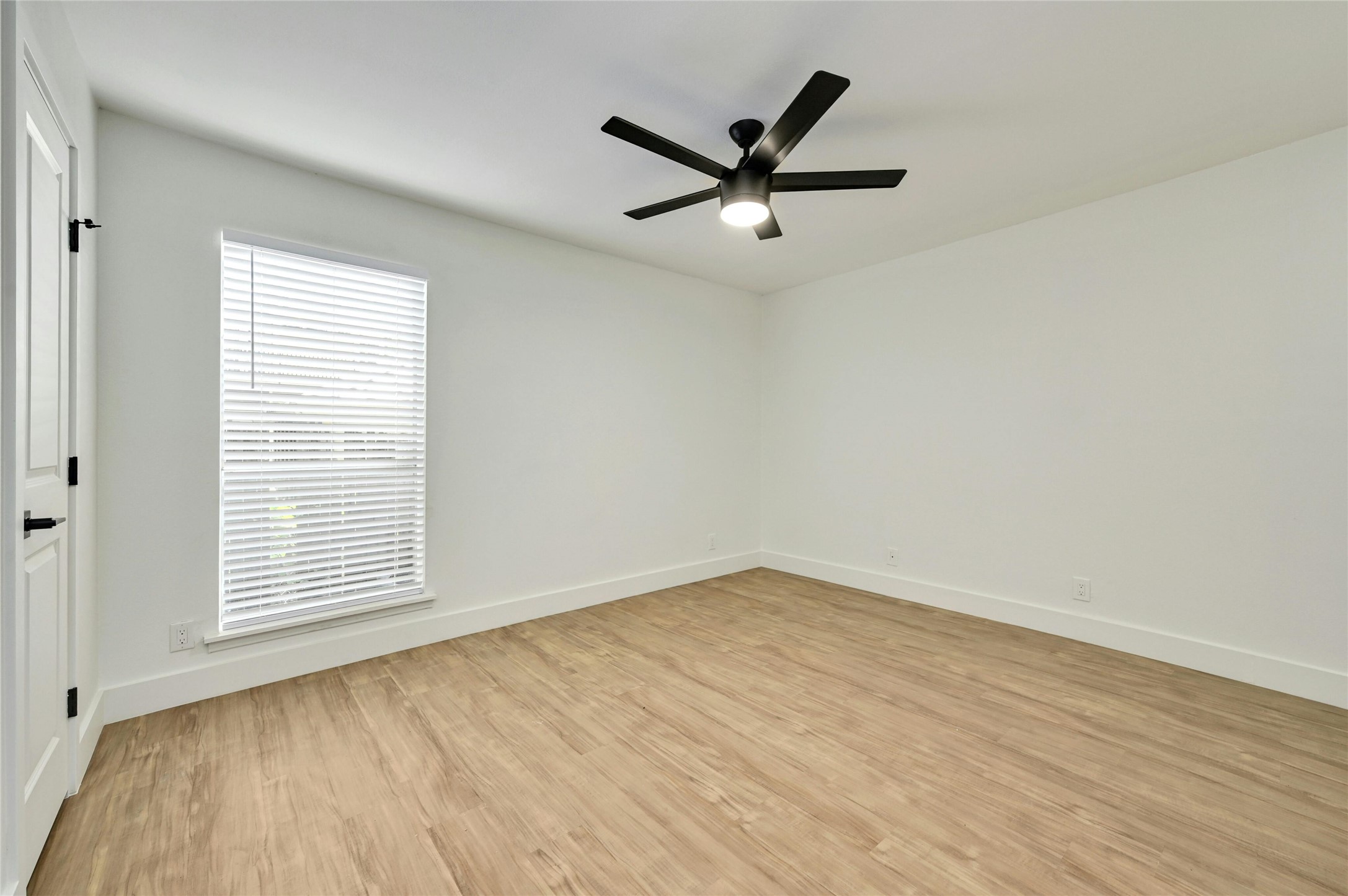 202 East 45th Street, Unit 103 Austin, TX 78751 - Photo 15 of 27 an empty room with wooden floor fan and windows