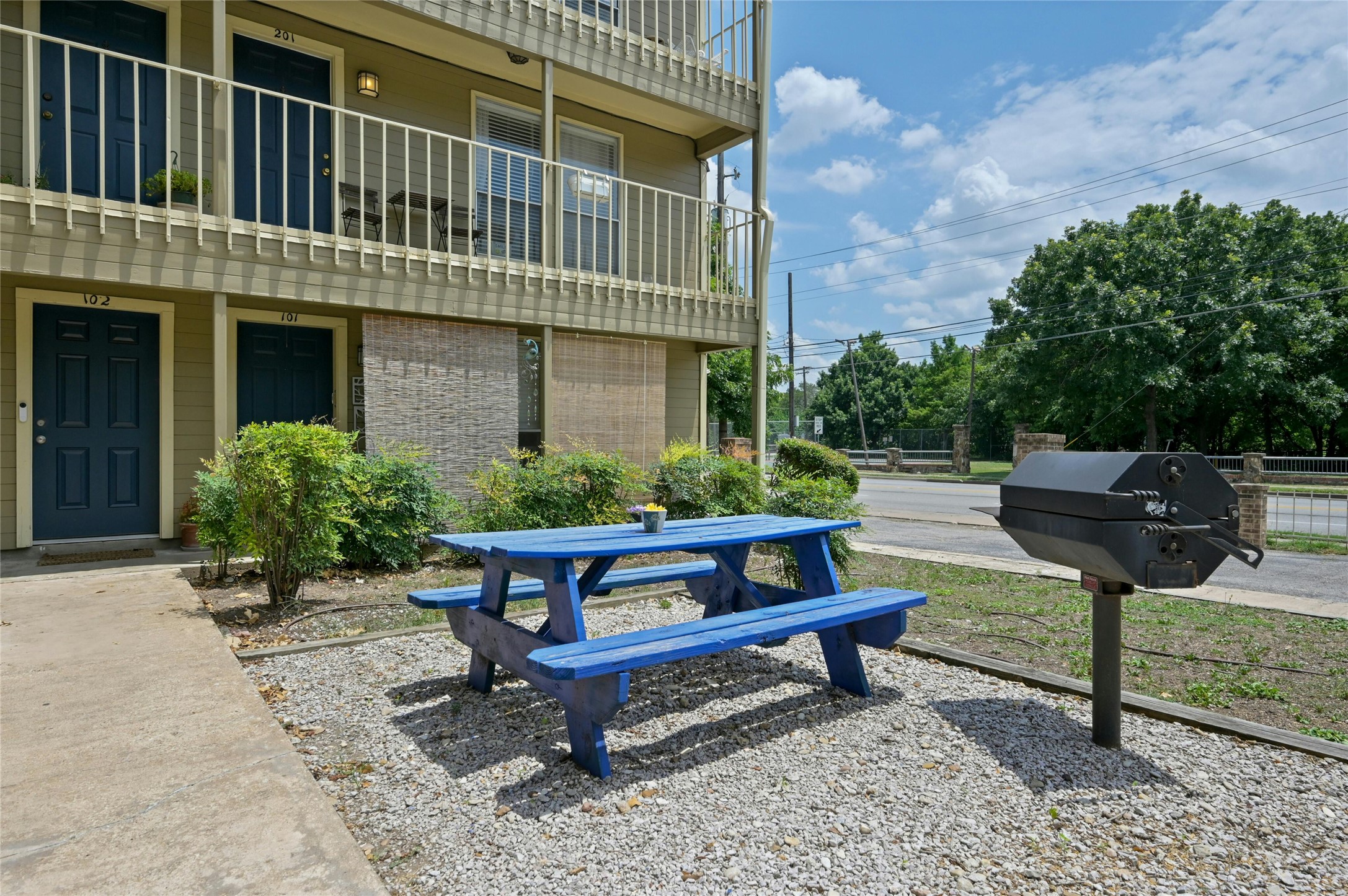 202 East 45th Street, Unit 103 Austin, TX 78751 - Photo 3 of 27 a backyard of a house with table and chairs