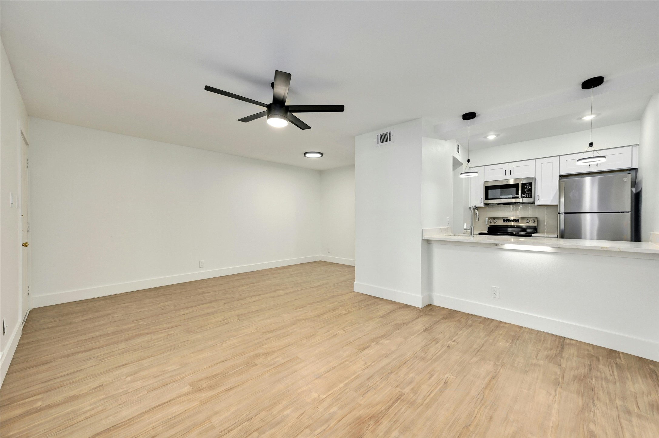 202 East 45th Street, Unit 103 Austin, TX 78751 - Photo 7 of 27 a view of a kitchen with a sink and stainless steel appliances