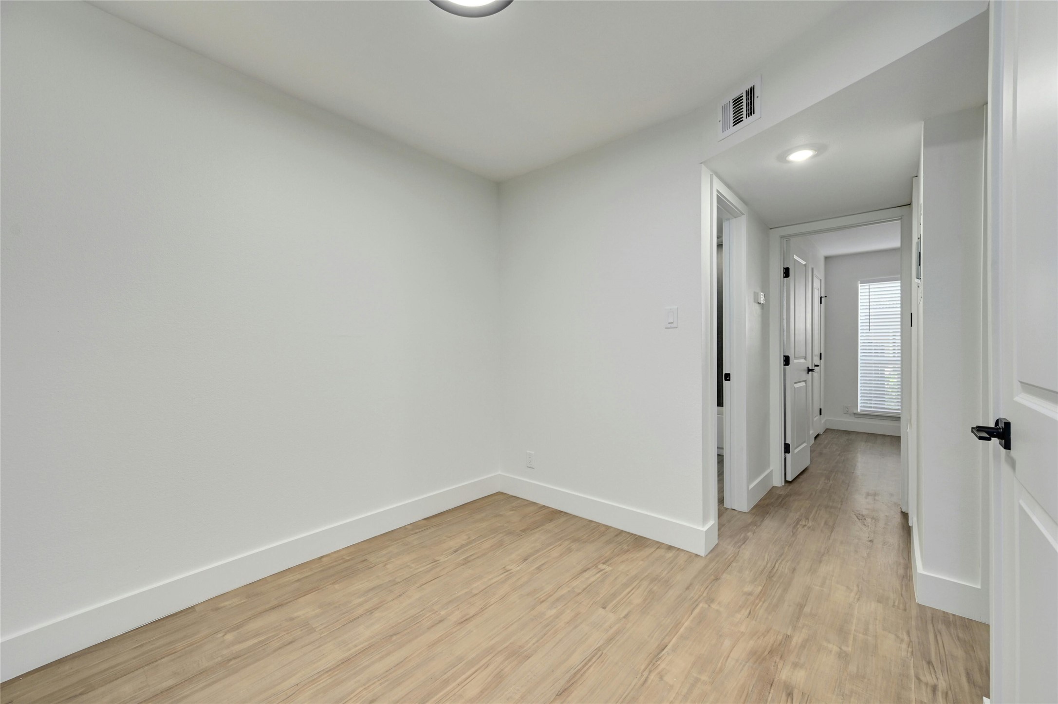 202 East 45th Street, Unit 103 Austin, TX 78751 - Photo 9 of 27 a view of a hallway with wooden floor and closet area