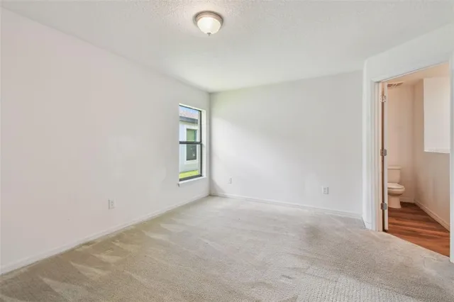 a view of a kitchen with wooden floor and a ceiling fan