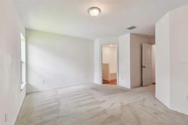 a bathroom with a granite countertop sink toilet mirror and shower