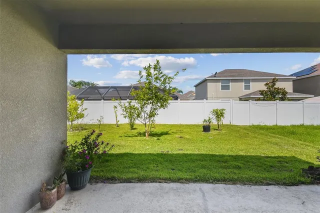 an aerial view of multiple houses with a yard