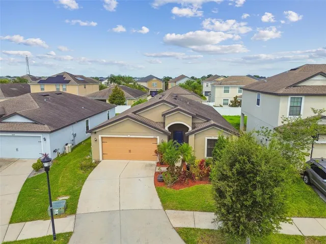 a view of a hallway with wooden floor and a bathroom
