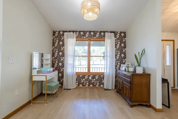a spacious bedroom with a bed and a chandelier
