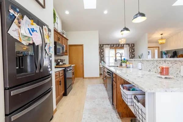 a kitchen with stainless steel appliances granite countertop a stove and cabinets