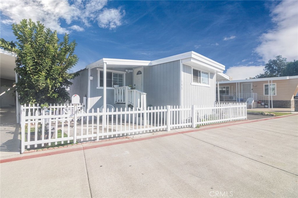 a view of a house with a wooden fence