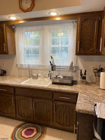 a kitchen with a sink and wooden cabinets